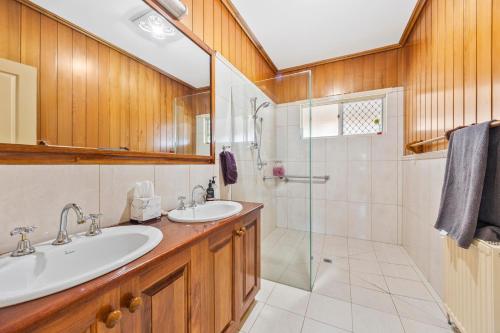 a bathroom with two sinks and a shower at Maureens Retreat in Eureka