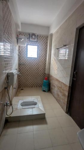 a bathroom with a shower and a toilet and a sink at Imperial Homestay in Patna