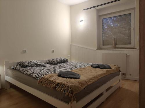 a bedroom with a bed with two pillows on it at Apartament Juliusz Slowacki in Szczawno-Zdrój