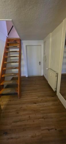 an empty room with a staircase in a house at Ferienwohnung "Dachblick" Bad Elster in Bad Elster