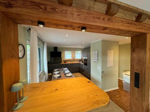 a kitchen with a large wooden table in a room at Eden Escapes in Olsberg