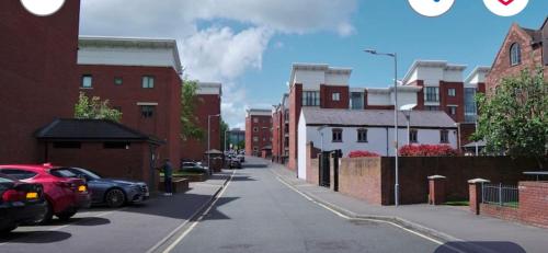 a city street with cars parked on the street at Olive Den in Wolverhampton
