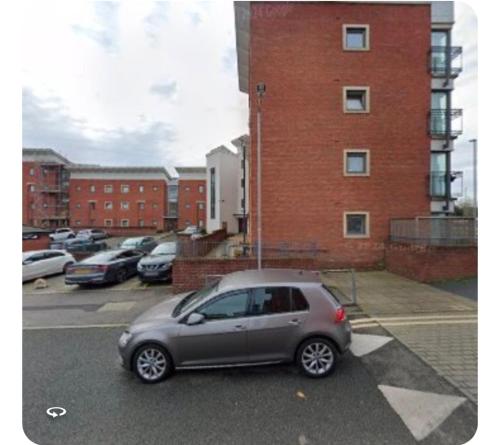 a small silver car parked in a parking lot at Olive Den in Wolverhampton