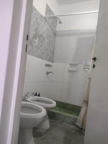 a bathroom with a toilet and a sink at Mendoza in Barraquero