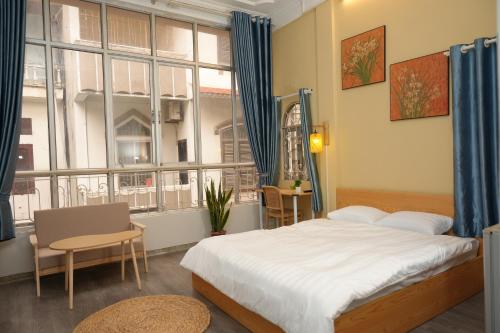 a bedroom with a bed and a large window at Four Seasons Serenity Studio - SDhousing branch in Hanoi