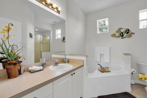 a white bathroom with a sink and a toilet at Much Needed Private Relaxation Home in Davenport