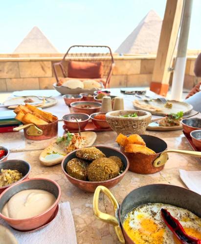 a table topped with bowls and plates of food at Fanton Hotel in Cairo