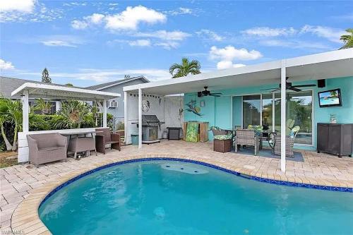 a swimming pool in front of a house at Summer Getaway (Gulf-access retreat) in Cape Coral