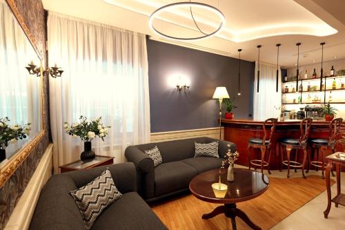 a living room with a couch and a table at Zeus Essence Bucharest Opera in Bucharest