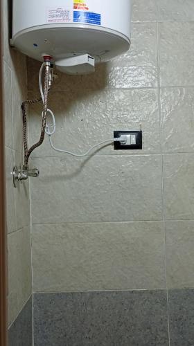 a water meter on the wall of a bathroom at Shellaly Ca Nubian Guest2 House in Jazīrat Salūjah