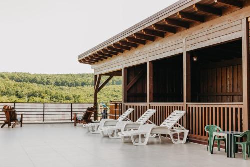 a group of chairs and tables on a deck at Baile Figa-Terasa Spa Cazare in Agrişu de Sus
