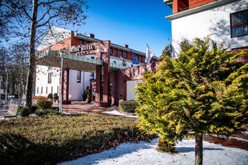 a christmas tree in front of a building at Dráva Hotel Thermal Resort in Harkány