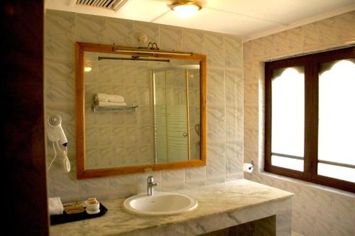 Dragon Nest Resort في Wangdiphodrang: حمام مزود بحوض ومِرآة