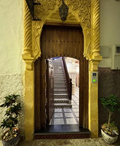 an entrance to a building with a wooden door at Riad Safia in Rabat