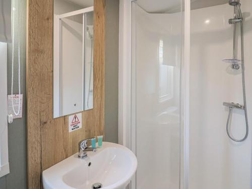 a bathroom with a sink and a shower at Jurassic Discovery in Charmouth
