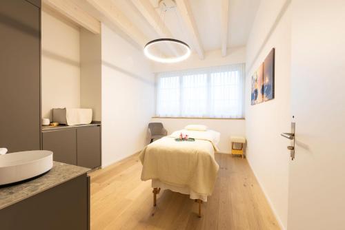 una habitación con una cama y un baño con lavabo en Seemöwe Swiss Quality Hotel, en Güttingen