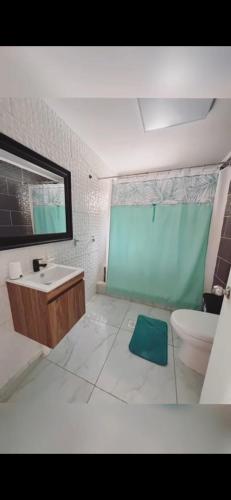 a bathroom with a sink and a toilet and a mirror at Cabaña Alfalfares Oriente in La Serena