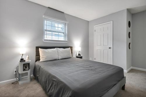 a bedroom with a bed with two night stands and two lamps at Black And White 1 BR by Ryan Korban in Durham
