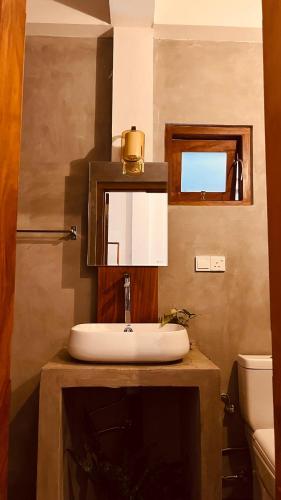 a bathroom with a sink and a mirror at Little J villa in Dickwella