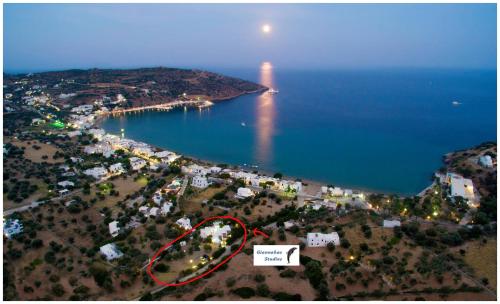 an aerial view of an island with a lighthouse in the water at Giannakas Studios in Platis Yialos Sifnos