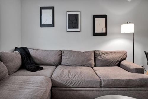 a couch in a living room with pictures on the wall at Black And White 1 BR by Ryan Korban in Durham