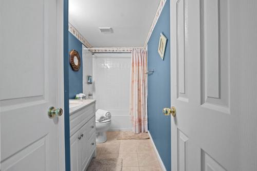 a bathroom with a white toilet and a shower at Fireplace • Grill • Gym‑Ready • Near Bull Run in Centreville