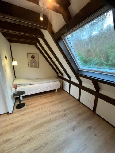 En eller flere senge i et værelse på Le chalet de Pfaffenbronn