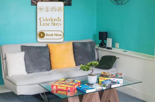 a living room with a couch and a glass table at King Apartment in Falkirk