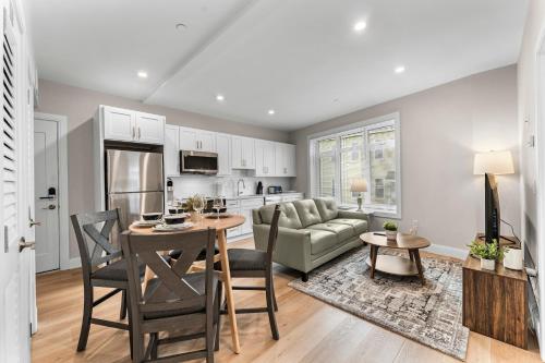 a kitchen and living room with a table and a couch at Luxury 2BR near Cabmridge in Somerville