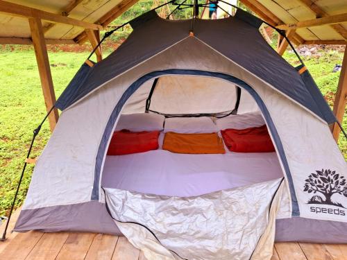 a tent with the door open on a deck at Aubrey Villa Ciwidey in Pengalengan