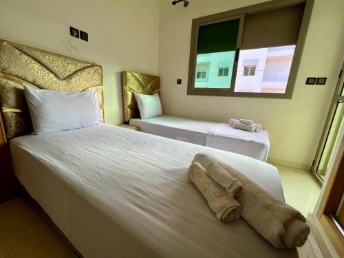 a hotel room with two beds and a window at Appart Hotel Noor Fes - Family & Traveler Apartments in Fez