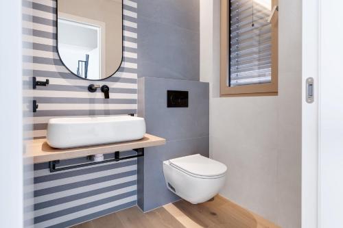 a bathroom with a white toilet and a mirror at Villa Mare Zadar in Zadar