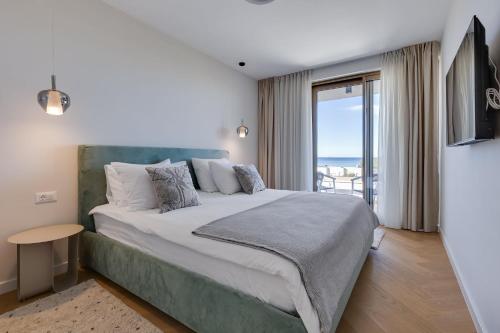 a bedroom with a bed with a view of the ocean at Villa Mare Zadar in Zadar