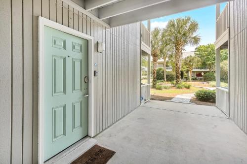 a green door on the side of a building at One Bedroom at Beachwood Villas on 30a in Seagrove, Florida in Santa Rosa Beach