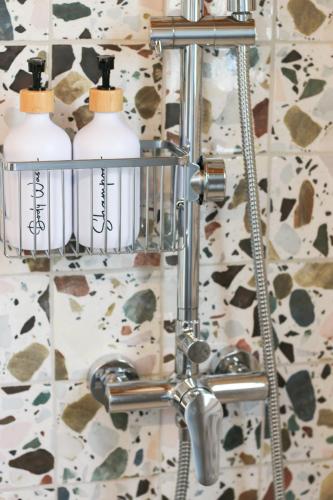 a bathroom with two soap bottles in a holder at La Caseta del tío Antonio in El Parral