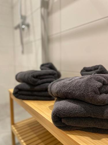 a pile of towels sitting on a shelf in a bathroom at Dottie's Place in Winterberg