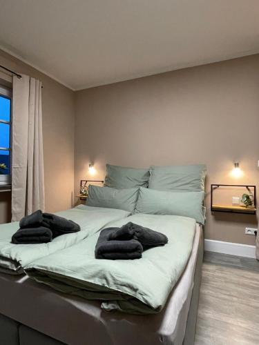 a bedroom with a large bed with two towels on it at Dottie's Place in Winterberg