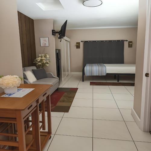 a living room with a couch and a table at Green Castle Apartment in Tampa 10 min from Airport and the Beach in Tampa