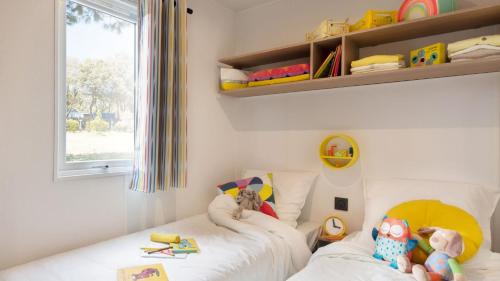 a childs bedroom with two beds with stuffed animals at Camping Tikayan Saint Clair - Maeva in Moustiers-Sainte-Marie