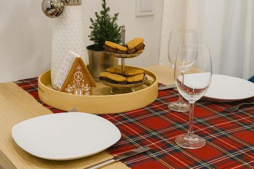 a table with glasses of wine and a tray of cookies at Gelbe Koffer - Design-Apartment in Schiffweiler - Self-Check-in - 2 Parkplätze - WLAN - Balkon mit Gartenzugang - private Terrasse - ruhig gelegen - Nähe See & Wald - bis 4 Pers in Schiffweiler