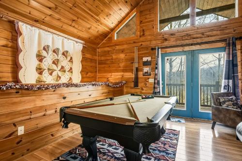 a pool table in a room with wooden walls at Tranquil View by American Patriot Getaways in Glade