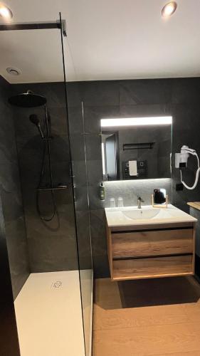 a bathroom with a sink and a shower at Annexe by Hôtel La Réserve in Gérardmer