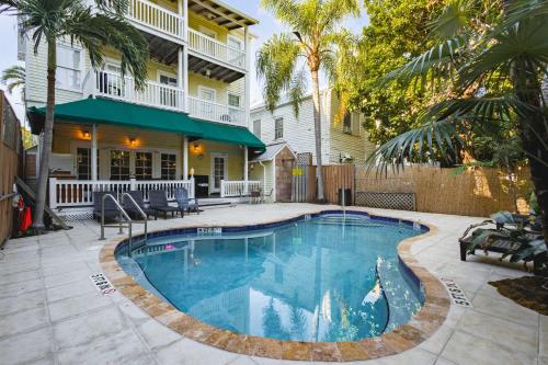 a swimming pool in front of a house at Curry House - Room 5 in Key West