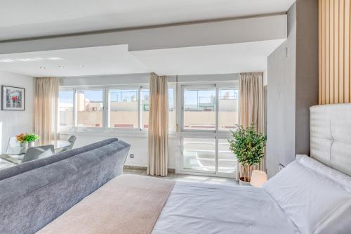 a living room with a couch and a table at Estepona Real Apartamentos in Estepona