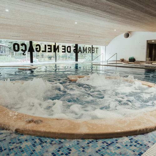 a jacuzzi tub filled with water in a building at PESO RIVER HOUSE in Melgaço