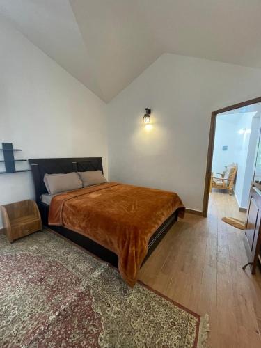 a bedroom with a bed with a brown blanket on it at IndivaStays - Moon Stone Villa in Ooty
