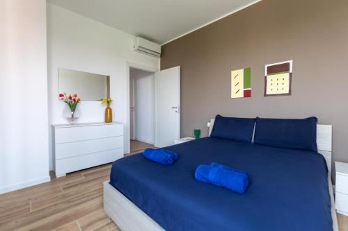 een slaapkamer met een groot blauw bed met blauwe kussens bij Milano - Open Space in Cusano Milanino