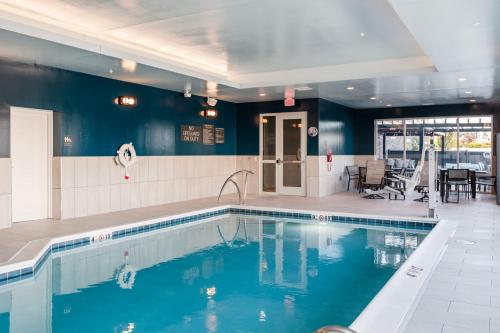 a swimming pool with blue water in a building at TownePlace Suites Dayton Beavercreek in Beavercreek