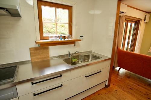 a kitchen with a sink and a window at THE KOYA Nagano in Nagano