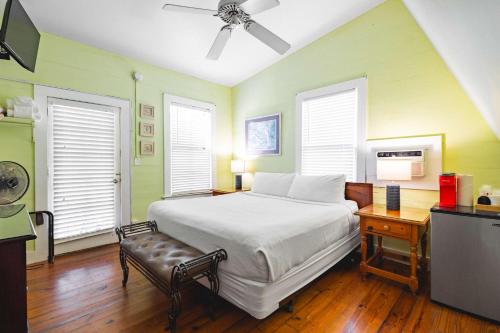 a bedroom with a bed and a television in it at Curry House - Pool, King Bed & Balcony! Room 7 in Key West